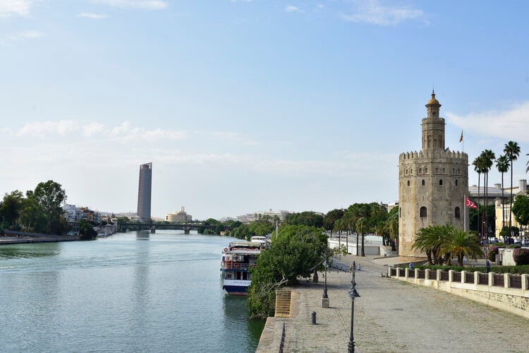 <span>The Guadalquivir river is at the heart of Sevilla, and its banks are a great place to read, relax, and soak up the Southern sun with locals</span>